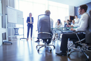 Group of business people listening to presentation in office