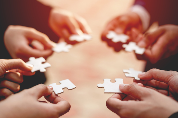 businessman with puzzle pieces in his hands