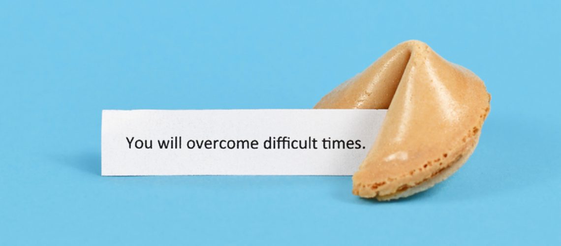 Fortune cookie with motivational text on paper saying