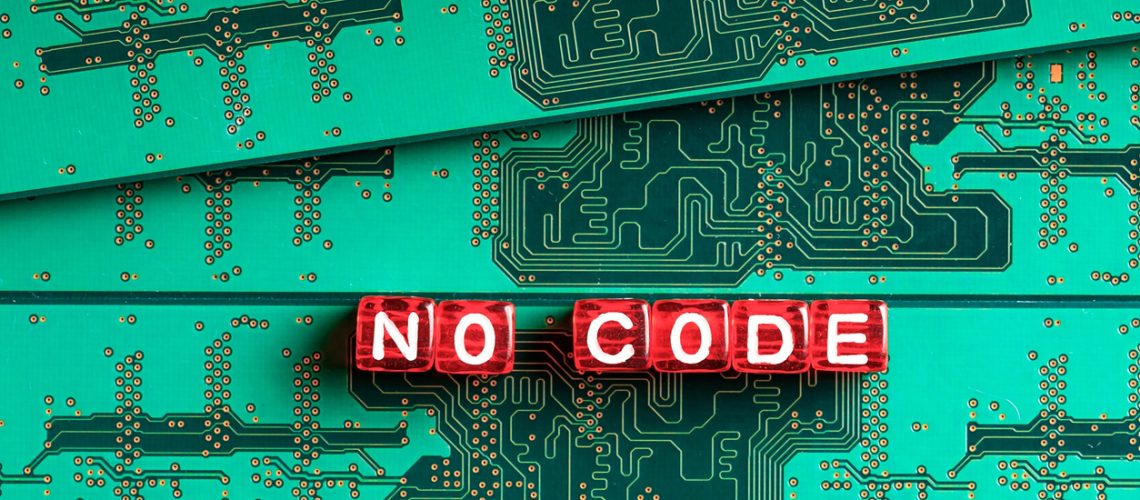 red cubes with the inscription no code on a green electrical circuit red cubes with the inscription no code on a green electrical circuit. out of focus circuitry