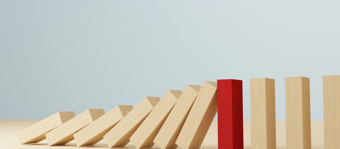 Risk management concept. Wooden block stopping domino effect for business. 3d render illustration