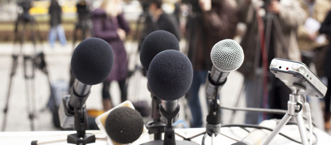 Microphones at a news conference. Press conference.