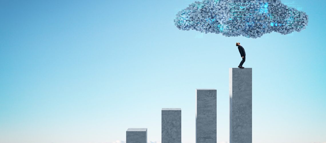 Man on concrete chart bars under abstract digital cloud with programming language on bright sky background. Digital storage, financial growth, database, network and technology concept