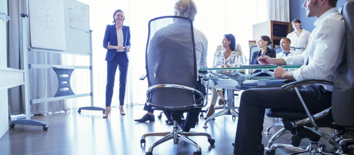 Group of business people listening to presentation in office