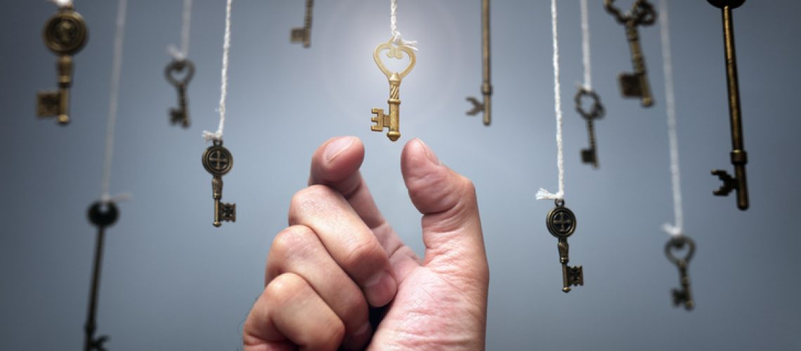 Choosing the key to success from hanging keys concept for aspirations, achievement and incentive